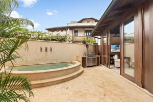 a backyard with a swimming pool and a house at Casa Maya in Potrero