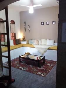 a living room with a couch and a coffee table at Hostel Mazoca in Peruíbe +84 photos