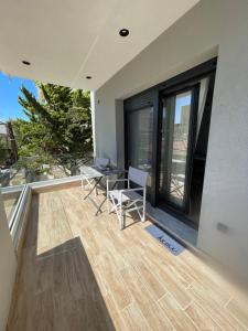 a patio with a table and chairs on a balcony at C&C3 Apartments in Alexandroupoli