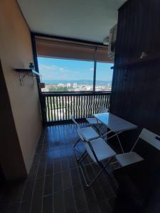 a balcony with a table and chairs and a view at Apartman Sofka in Vranje
