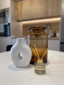a jar and a vase sitting on a counter at C&C3 Apartments in Alexandroupoli