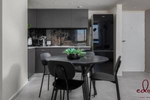 a kitchen with a table and chairs in a room at סוויטת View חדר שינה וסלון במתחם סי סייד in Eilat