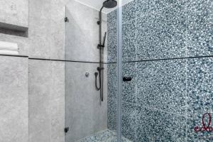 a shower with a glass door in a bathroom at סוויטת View חדר שינה וסלון במתחם סי סייד in Eilat +14 photos