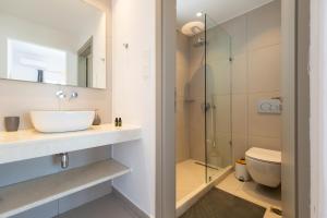a bathroom with a sink and a shower at ALTHEA PAROS in Naousa +14 photos