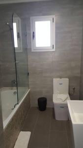 a bathroom with a toilet and a shower and a sink at Villa con vistas al mar y piscina privada Oued Aliane in Mrarech