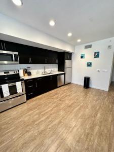 a large kitchen with wooden floors and stainless steel appliances at Studios Universal 10 min drive FREE parking and WIFI in Los Angeles
