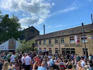 a crowd of people standing in front of a building at Farsley Studio in Farsley