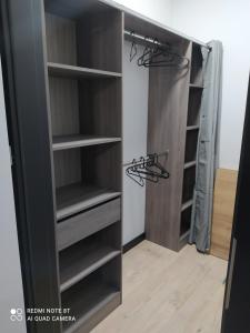 a walk in closet with black cabinets and shelves at Nowoczesny Apartament Królowej Jadwigi in Radom