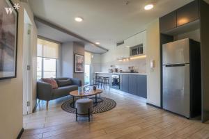 a kitchen and living room with a couch and a table at Pionero by Wynwood House in Lima