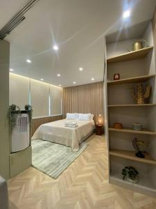 a bedroom with a bed and a book shelf at Mercadoflat in Póvoa de Varzim