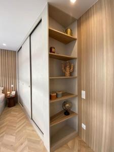 a room with a closet with shelves in it at Mercadoflat in Póvoa de Varzim