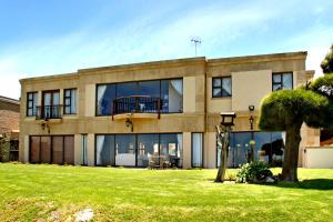a large building with a balcony on top of it at Casa Mia Guesthouse in Table View