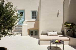 a living room with a couch and a table at Arxegono Cave Houses Santorini in Pyrgos