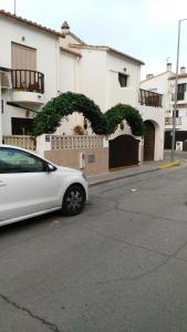a white car parked in front of a building at Casa a 5 minutos playa Riells in L'Escala