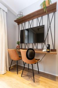 Uma TV ou centro de entretenimento em Charlie Hotel Atmosfera Paulista