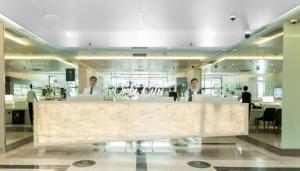 a lobby with a bar in the middle of a building at Batumi Orbi City Lux Apartment 5* in Batumi