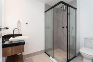 a bathroom with a shower and a sink at Charlie Hotel Atmosfera Paulista in Sao Paulo