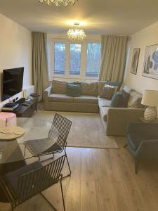 a living room with a couch and a table at Experience Torridon House Maida Vale in London