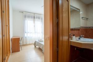 a bathroom with a sink and a mirror at TrendyHomes Train Station in Almería