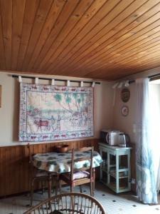 a room with a table and a tapestry on the wall at la maison de Juliette En bas in Lascabanes