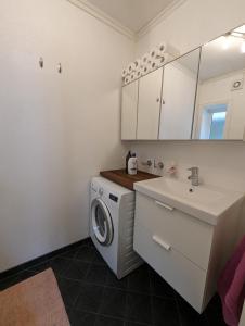 a bathroom with a washing machine and a sink at Apartment in Ålesund city center (Storgata) in Ålesund