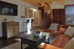 a living room with a couch and a table at Hobbit House - Charming In Town in Idyllwild