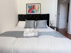 a bedroom with a bed with two towels on it at Luxurious 2-Bedroom, 2-Bathroom Paddington Retreat with En-Suite TV Bed in London