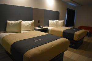 a hotel room with two beds in a room at Blue Star Inn in Houston