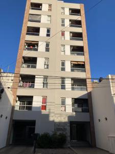 a tall apartment building with a lot of windows at Portales I in Santa Fe
