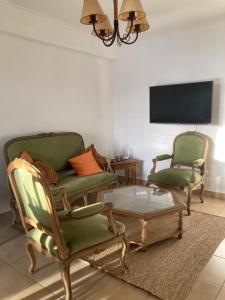 a living room with two chairs and a coffee table at Portales I in Santa Fe