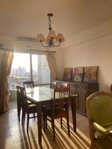 a dining room with a table and chairs and a window at Portales I in Santa Fe