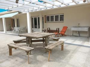 a picnic table and benches on a patio at Le lion d'or dans le 66 in Amélie-les-Bains-Palalda