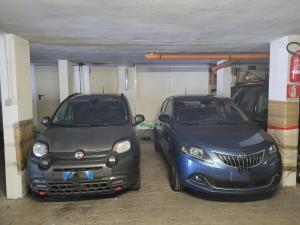 two cars parked next to each other in a garage at Appartamento in villa Ryder Cup in Marco Simone