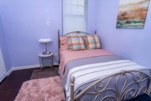 a bedroom with a bed with a pillow and a table at Holiday Apartment Dominica in Glanvillia