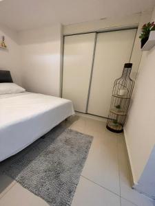 a bedroom with a bed and a vase on the wall at Estrela Mares Haifa apartment in Haifa