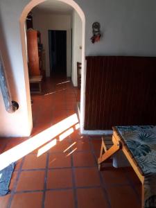 a room with a red tile floor and an open door at Alojamiento hostel Lodeolga "La Florida" in Rosario