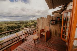 a balcony of a house with a bench on it at Pousada Campeira in Brotas