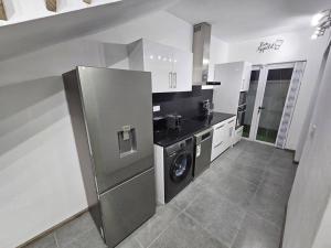 a kitchen with a washer and dryer in it at Rooftop Spa Luxury Villa in Rivière Noire