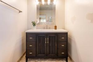 a bathroom with a sink and a mirror at Stylish Guest House with Ocean & City Views in San Diego