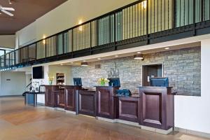 a lobby with a bar with brown cabinets and a staircase at Best Western Pembroke Inn & Conference Centre in Pembroke