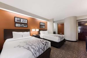 two beds in a hotel room with two beds sidx sidx sidx at Sleep Inn Kernersville I-40 in Kernersville