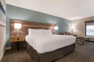 a large bed in a hotel room with two lamps at Best Western Flagship Inn in Moss Point +20 photos
