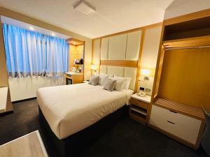 Tempat tidur dalam kamar di OQ MIRADOR CLASSIC - AIRPORT
