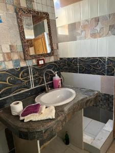 a bathroom with a sink and a mirror at Haven Hideaway - The Summer Moon House in Dahab