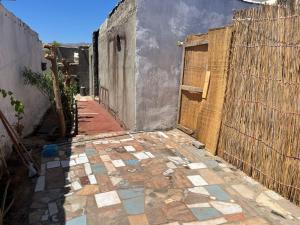 an alley with a fence and a tile floor at Haven Hideaway - The Summer Moon House in Dahab