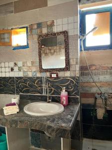 a bathroom with a sink and a mirror at Haven Hideaway - The Summer Moon House in Dahab