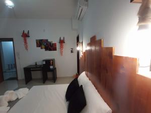 a bedroom with a bed with white sheets and pillows at Central Palace Hotel in Fortaleza