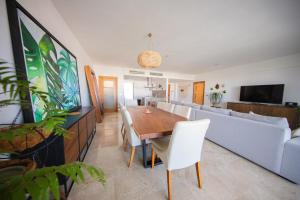 a living room with a dining room table and a couch at Beautiful apartment by the beach! in Cancún