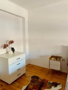 a bedroom with a white dresser and a fur rug at City Center Square DeLuxe Nest in Podgorica