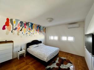 a bedroom with a bed and a tv in it at City Center Square DeLuxe Nest in Podgorica